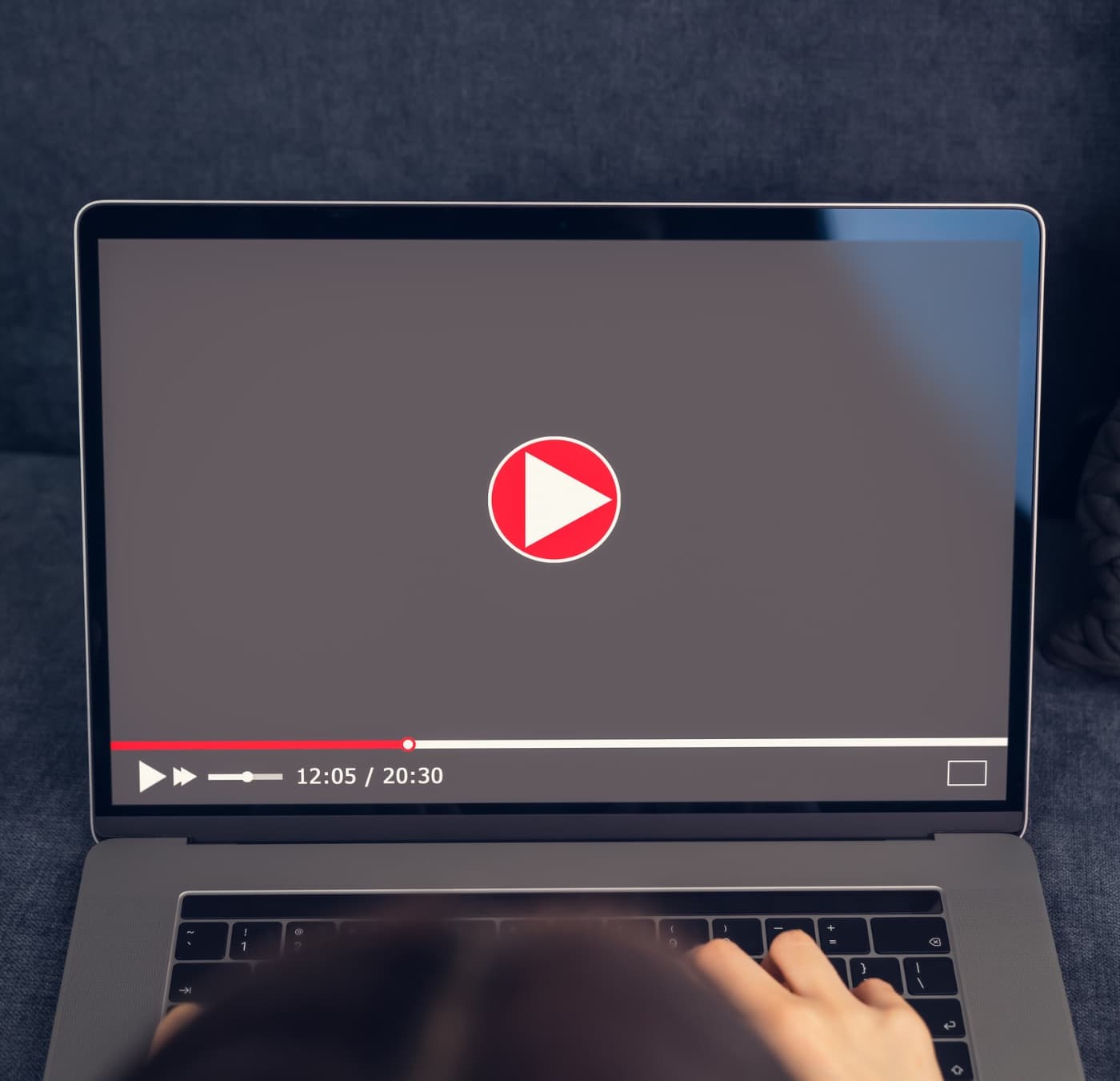 A video tutorial playing on a laptop